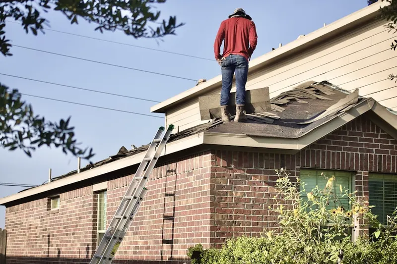 Professional roofer working on a residential roof in Hollywood Hills West